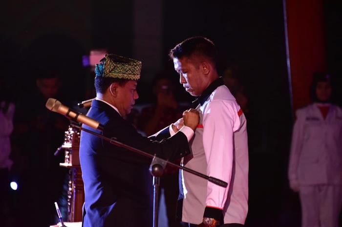Ketua KONI Riau Emizal Pakis menyematkan pin kepada ketua KONI Bengkalis Darma Firdaus S saat acara pelantikan pengurus KONI Bengkalis periode 2018-2020.