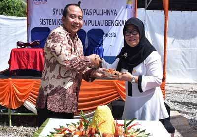  Asisten Tata Praja Hj Umi Kalsum bersalaman dengan General Manager Unit Induk wilayah Riau dan Kepulauan Riau Irwansyah usai pemotongan tumpeng.