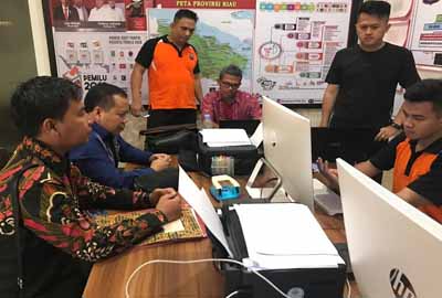 Bupati Kepulauan Meranti Irwan Nasir didampingi Kuasa Hukumnya Bonny Nofriza saat membuat laporan di kantor Ditreskrimsus Polda Riau, Jumat (11/1/2019).