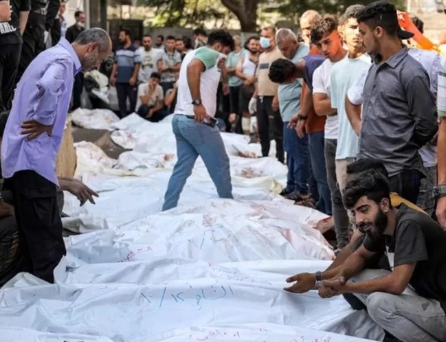 Perang di Gaza Kamar mayat di rumah sakit terbesar di Gaza penuh sesak ketika serangan Israel meningkat Orang-orang berdiri di dekat jenazah korban serangan udara Israel di luar kamar mayat rumah sakit Al-Shifa di Kota Gaza pada 12 Oktober 2023. (FOTO: AFP)
