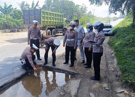 Tim Ditlantas Polda Riau saat melakukan survei jalan rusak di Jalan Parit Indah Ujung Pekanbaru.(foto: mcr)