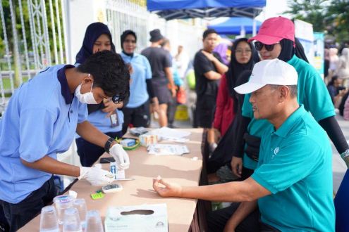 Pj Sekdaprov Riau, Taufiq OH saat mencoba layanan cek kesehatan gratis dalam momen HKN ke-60 yang ditaja Diskes Riau.(foto: mcr)