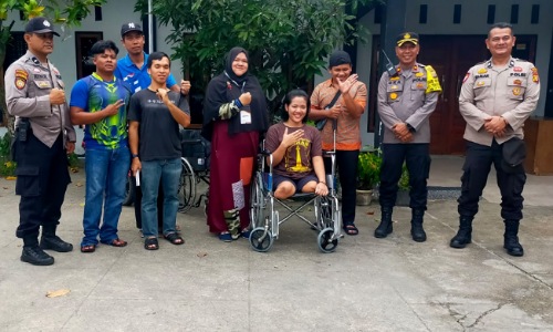 Personel Polsek Tenayan Raya bersama pemilih disabilitas.(foto: istimewa)