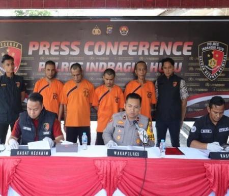 Polisi saat menunjukkan barang bukti uang palsu.