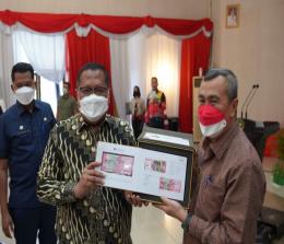 Gubernur Riau Syamsuar menerima uang Rupiah kertas baru TE 2022 dari Kepala BI Perwakilan Riau M Nur usai peluncuran 7 uang Rupiah kertas baru TE 2022 secara virtual.(foto: mcr)